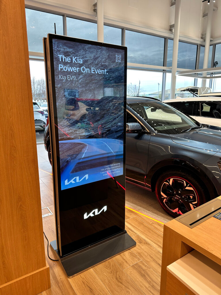 Kia showroom digital screens showcasing the latest marketing campaigns